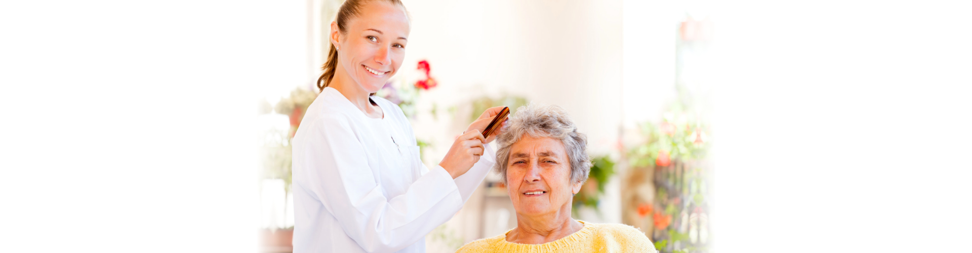 woman combing hair of elderly woman