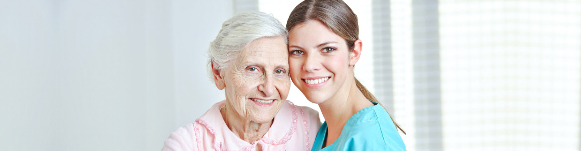 elderly woman hugging her caregiver